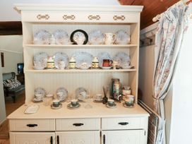 A kitchen with plates and cups displayed on a shelf at Gullane East in Rathmore, County Kerry