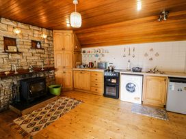 A kitchen with cabinetry, appliances, and a rug at Gullane East in Rathmore, County Kerry