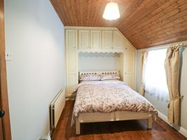 A bedroom with a bed and shelves at Gullane East in Rathmore, County Kerry