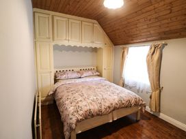 A bedroom with a bed and wardrobe at Gullane East, Rathmore, County Kerry