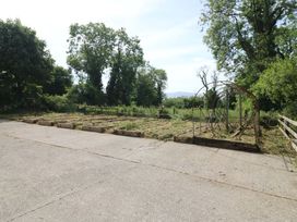 A garden with trees and raised beds at Gullane East in Rathmore, County Kerry