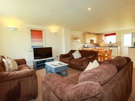 A living room with a sofa and television at 4 bed number 2 Atlantic Reach near St Columb Road
