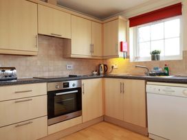 A kitchen with cabinets, oven, and sink at 4 bed number 2 Atlantic Reach near St Columb Road