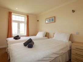 A bedroom with two beds and a window at 4 bed number 2 Atlantic Reach near St Columb Road