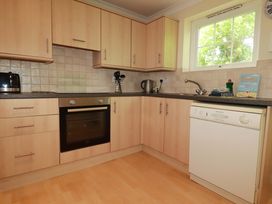 A kitchen with cabinets and appliances at 4 bed number 20 Newquay