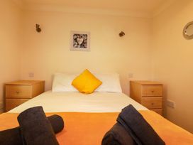 A bedroom with a bed and nightstands at 4 bed number 20 Newquay