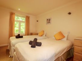 A bedroom with two beds and a window at 4 bed number 20 Newquay