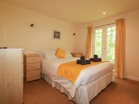A bedroom with a bed and a chest of drawers at 4 bed number 20 Newquay
