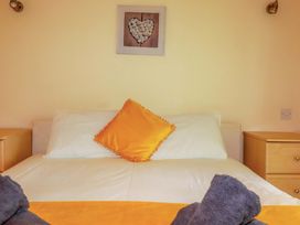 A bedroom with a bed and decorative elements at 4 bed number 20 Newquay