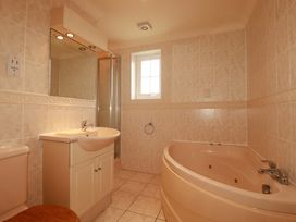 A bathroom with a sink, toilet, shower, and bathtub at 4 bed number 20 Newquay