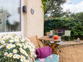 An outdoor area with a table and chairs at La'al Yan in Branthwaite