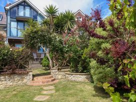 A house with a garden and pathway at Little Gem in Weymouth