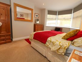 A bedroom with a bed and wardrobe at Little Gem in Weymouth