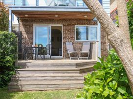 A patio area with a table and chairs at Little Gem in Weymouth