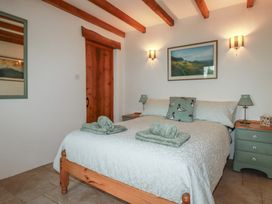 A bedroom with a bed and bedside tables at Cider Cottage