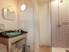 A bathroom with a wash basin and shower at Cider Cottage