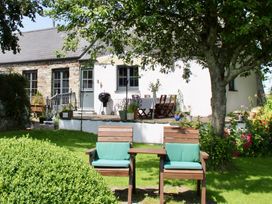 An outdoor area with chairs and a table at Cider Cottage near Launceston