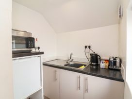 A kitchen with a sink and appliances at Coach House Highampton near Black Torrington