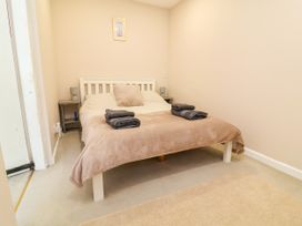 A bedroom with a bed and bedside table at Coach House Highampton near Black Torrington