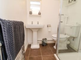 A bathroom with sink, toilet, and shower at Coach House Highampton near Black Torrington