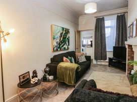 A living room with a sofa and coffee table at 24 Harrington Road Workington