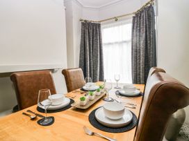 A dining room with a table set for a meal at 24 Harrington Road Workington