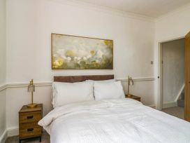 A bedroom with a bed and bedside tables at 24 Harrington Road in Workington