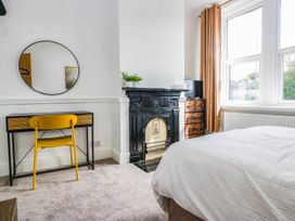 A bedroom with a desk and chair at 24 Harrington Road Workington