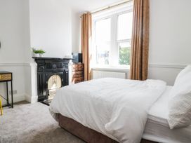 A bedroom with a bed and a fireplace at 24 Harrington Road in Workington