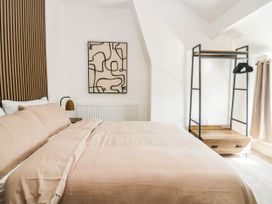 A bedroom with a bed and clothes rack at 24 Harrington Road in Workington