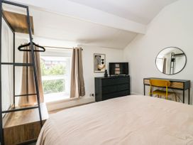 A bedroom with a bed, dresser, and mirror at 24 Harrington Road Workington