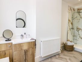A bathroom with a shower and sink at 24 Harrington Road Workington