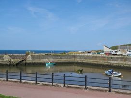 A harbor with boats and water at 24 Harrington Road, Workington