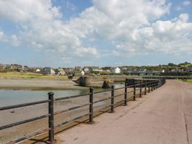 A view of a path by the water with houses in the background at 24 Harrington Road, Workington