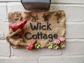 A name plaque with decorative elements at Wick Cottage in Whitby