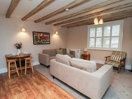 A living room with a sofa and dining table at Wick Cottage in Whitby