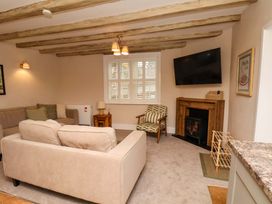 A living room with a sofa and fireplace at Wick Cottage in Whitby