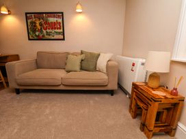 A living room with a sofa and a table at Wick Cottage in Whitby
