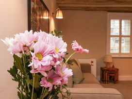 A living room with flowers and a couch at Wick Cottage in Whitby