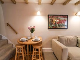 A dining area with a table set and a sofa at Wick Cottage in Whitby