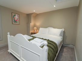 A bedroom with a bed and a bedside lamp at Wick Cottage in Whitby