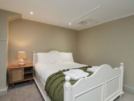 A bedroom with a bed and bedside lamp at Wick Cottage in Whitby