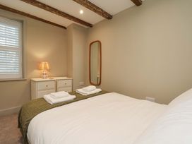 A bedroom with a bed and lamp at Wick Cottage in Whitby
