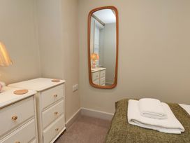 A bedroom with a bed and lamp at Wick Cottage in Whitby