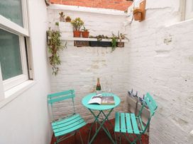 An outdoor space with a table and chairs at Pixie Cottage in Weymouth