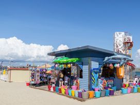 A beach hut selling toys and inflatables at Pixie Cottage in Weymouth