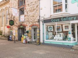 An outdoor shopfront with Londis Harbour Stores and Cove Gallery at Pixie Cottage Weymouth