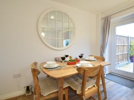 A dining room with a table set for a meal at Lapwings, Aldeburgh