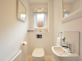 A bathroom with a toilet and sink at Lapwings, Aldeburgh