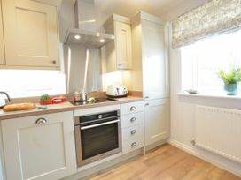 A kitchen with cabinets and appliances at Lapwings, Aldeburgh
